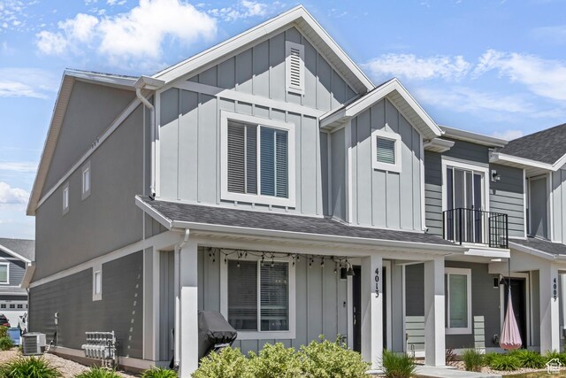 4013 W Cool Ave, Lehi, UT 84043 - view of front of property featuring board and batten siding, central air condition unit, a balcony, and roof with shingles