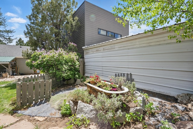 view of home's exterior featuring fence