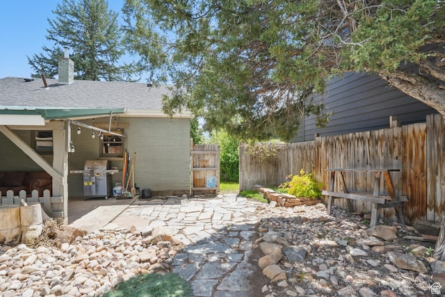 view of patio / terrace with a grill and fence