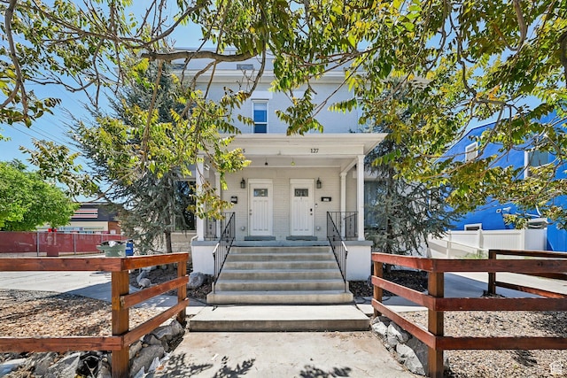 125 W 800 S, Salt Lake City, UT 84101 - view of front facade featuring covered porch and a fenced front yard