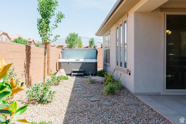 273 N Puerta Dr W, Washington, UT 84780 - view of yard featuring fence, a patio area, a mountain view, and a hot tub