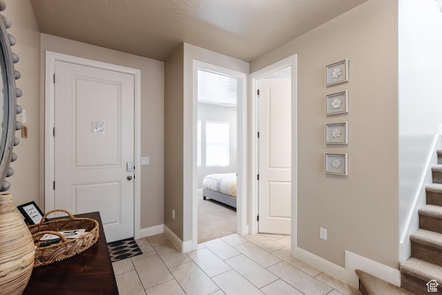 273 N Puerta Dr W, Washington, UT 84780 - foyer entrance with stairs, baseboards, light tile patterned floors, and light colored carpet