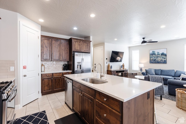 273 N Puerta Dr W, Washington, UT 84780 - kitchen with stainless steel appliances, a sink, tasteful backsplash, recessed lighting, and light countertops