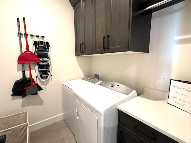 39 W Tamarind Way, Garden City, UT 84028 - clothes washing area with cabinet space, washing machine and clothes dryer, baseboards, and light wood-style floors