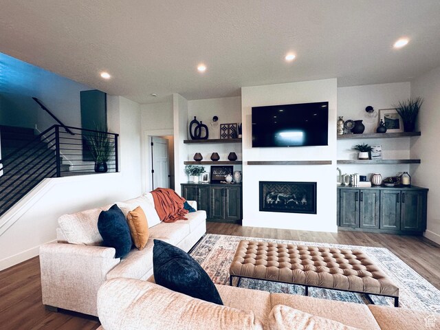 39 W Tamarind Way, Garden City, UT 84028 - living room with stairway, wood finished floors, a fireplace, recessed lighting, and baseboards