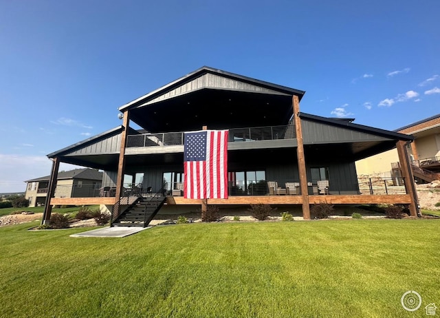 39 W Tamarind Way, Garden City, UT 84028 - rear view of property with a yard, stairs, and board and batten siding