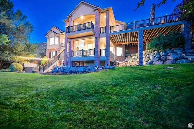 8 Snow Forest Cv, Sandy, UT 84092 - back of house at twilight featuring a balcony, stairs, a lawn, and stucco siding