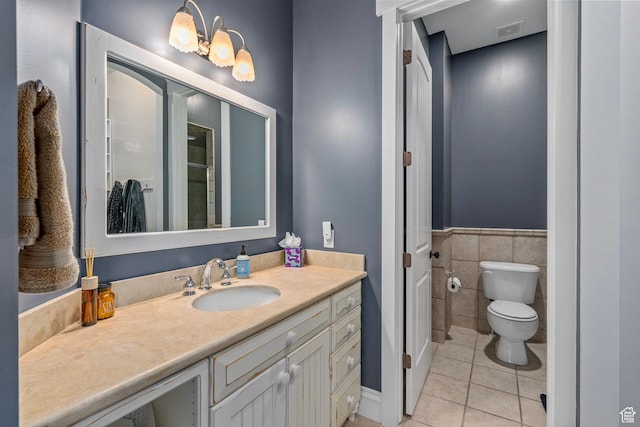 8 Snow Forest Cv, Sandy, UT 84092 - full bathroom with tile patterned floors, toilet, tile walls, vanity, and wainscoting
