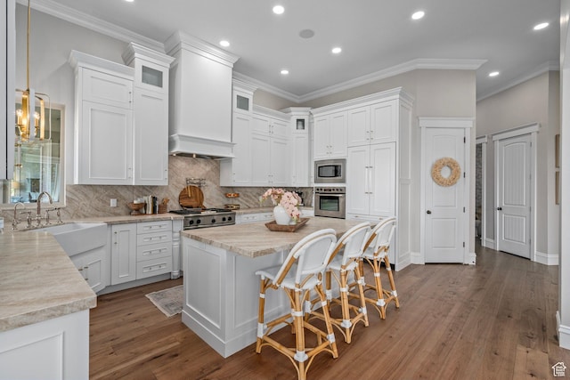 8 Snow Forest Cv, Sandy, UT 84092 - kitchen with stainless steel appliances, white cabinetry, crown molding, tasteful backsplash, and recessed lighting