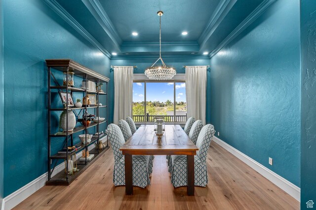 8 Snow Forest Cv, Sandy, UT 84092 - dining area featuring a raised ceiling, a chandelier, crown molding, wood finished floors, and baseboards