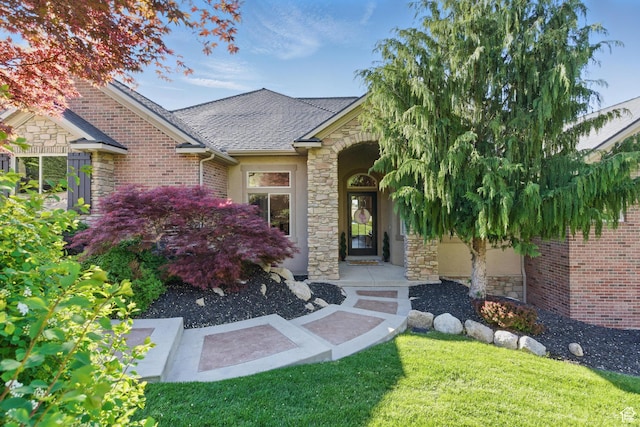 8 Snow Forest Cv, Sandy, UT 84092 - entrance to property featuring stone siding, a shingled roof, and a lawn