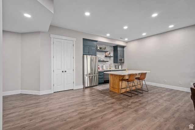 8 Snow Forest Cv, Sandy, UT 84092 - kitchen featuring appliances with stainless steel finishes, open shelves, light countertops, wood finished floors, and tasteful backsplash