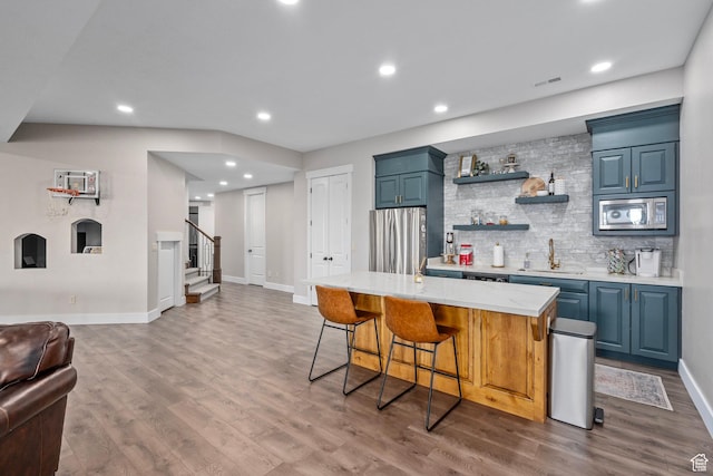 8 Snow Forest Cv, Sandy, UT 84092 - indoor wet bar with stainless steel appliances, stairs, wood finished floors, baseboards, and recessed lighting