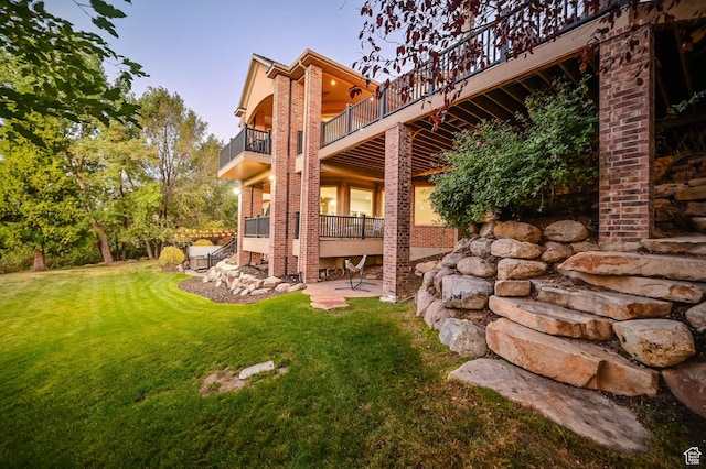 8 Snow Forest Cv, Sandy, UT 84092 - back of house featuring a balcony, a lawn, and a patio area