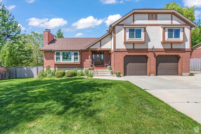 561 E 2780 N, Provo, UT 84604 - tudor-style house with a chimney, concrete driveway, brick siding, a garage, and stucco siding
