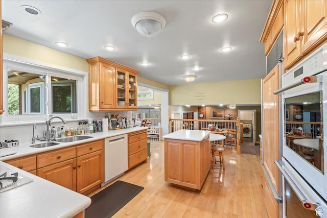 561 E 2780 N, Provo, UT 84604 - kitchen featuring a sink, white appliances, a breakfast bar, light countertops, and light wood-style flooring