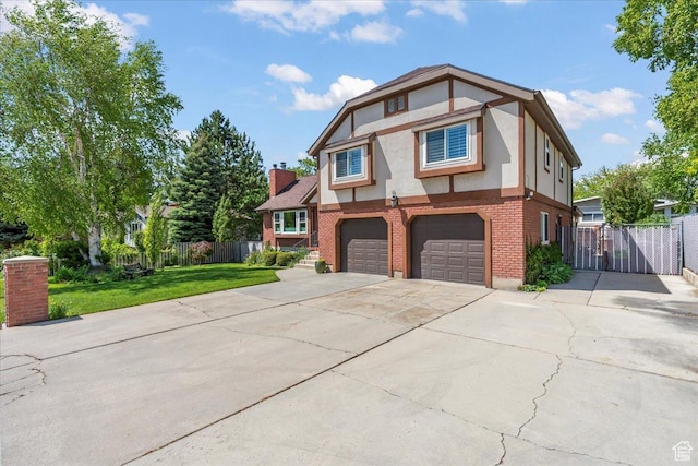 561 E 2780 N, Provo, UT 84604 - tudor house with brick siding, stucco siding, a garage, driveway, and a gate