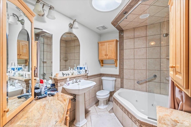 561 E 2780 N, Provo, UT 84604 - bathroom featuring a tub with jets, tile walls, tile patterned floors, a sink, and toilet