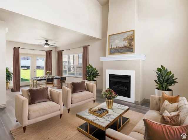 5117 W Fortrose Dr, Herriman, UT 84096 - living area featuring wood finished floors, a fireplace, ceiling fan, and french doors