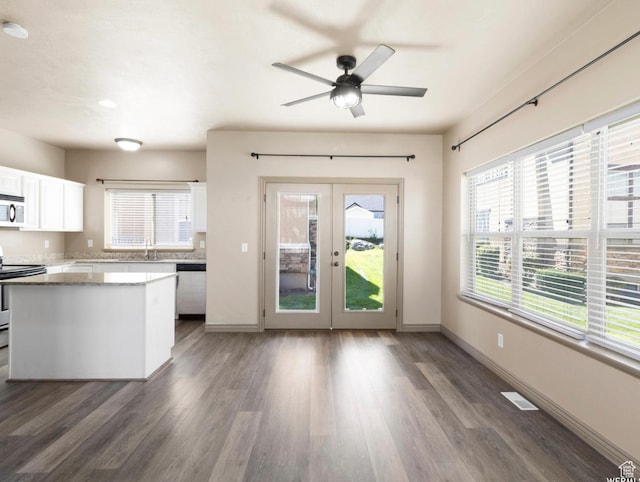 5117 W Fortrose Dr, Herriman, UT 84096 - kitchen featuring appliances with stainless steel finishes, french doors, a sink, white cabinetry, and wood finished floors
