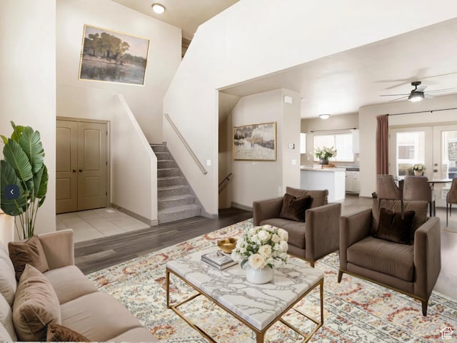 5117 W Fortrose Dr, Herriman, UT 84096 - living room featuring light wood-type flooring, stairs, a ceiling fan, and baseboards