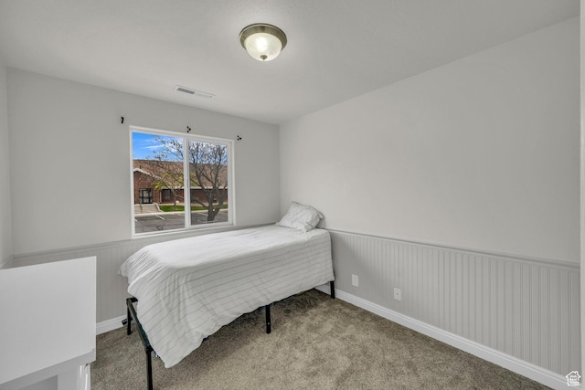 carpeted bedroom with wainscoting