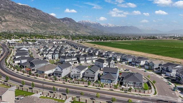 aerial view of property and surrounding area with a mountainous background and nearby suburban area