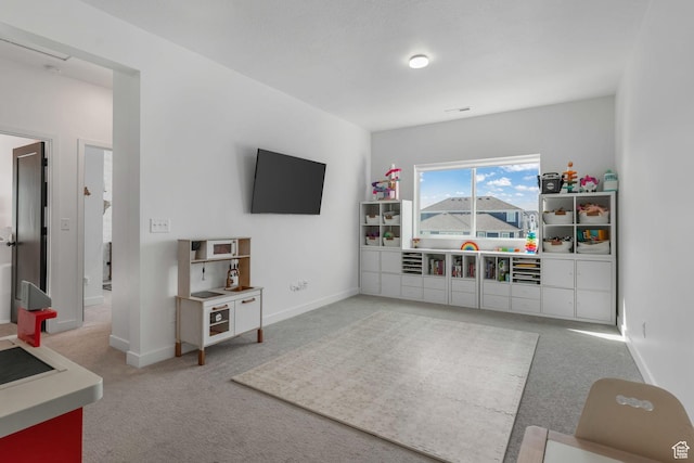 rec room featuring carpet and baseboards