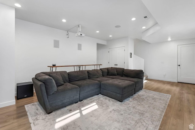 living area with light wood-style flooring, recessed lighting, and baseboards