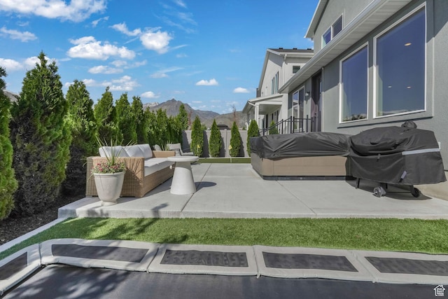 view of patio / terrace featuring area for grilling, a mountain view, and outdoor lounge area