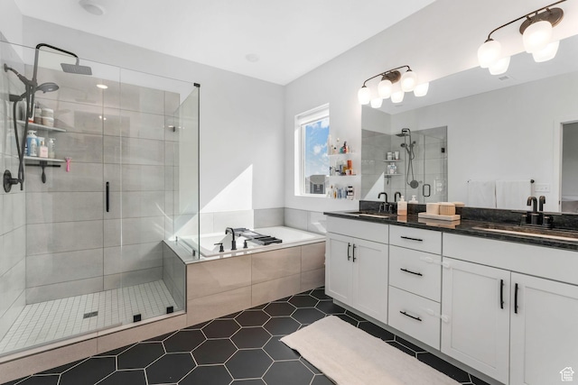 full bath with a shower stall, tile patterned floors, a garden tub, and double vanity