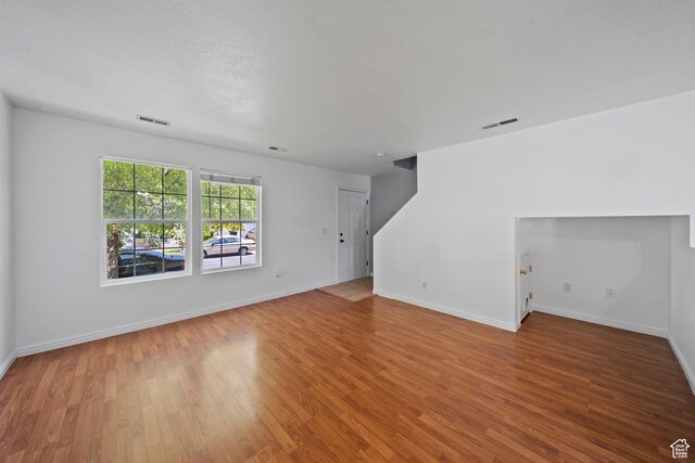 1957 N 2225 W, Clinton, UT 84015 - unfurnished living room featuring wood finished floors and baseboards