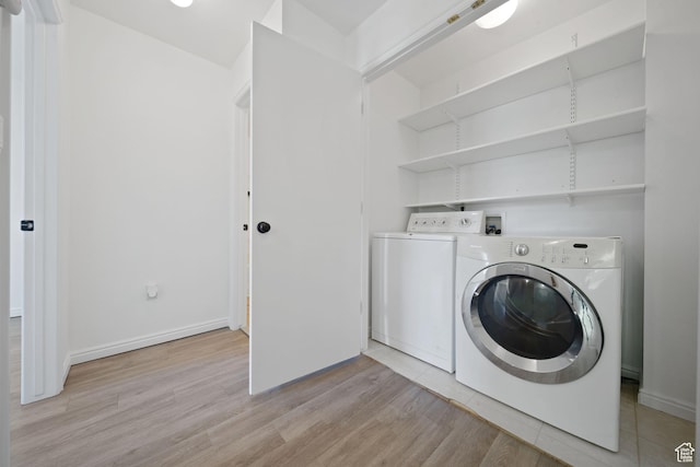 1957 N 2225 W, Clinton, UT 84015 - clothes washing area featuring separate washer and dryer, light wood finished floors, and baseboards