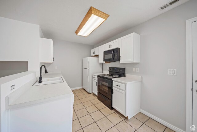 1957 N 2225 W, Clinton, UT 84015 - kitchen with black appliances, a sink, baseboards, white cabinets, and light tile patterned floors