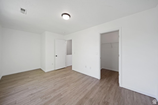 1957 N 2225 W, Clinton, UT 84015 - unfurnished bedroom featuring light wood-style flooring, baseboards, a spacious closet, and a closet