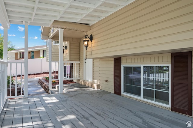 wooden terrace featuring fence