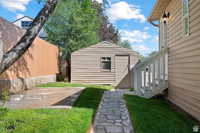 view of yard featuring an outdoor structure and a patio
