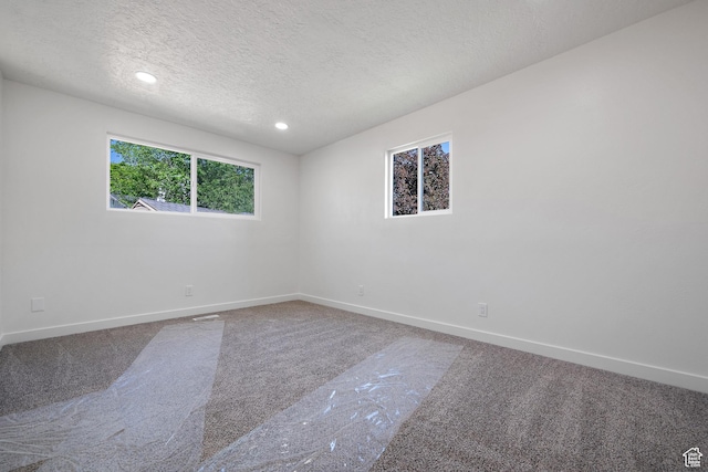 unfurnished room featuring carpet flooring, baseboards, a textured ceiling, and recessed lighting