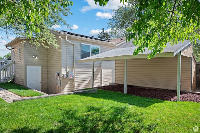 rear view of property with a yard