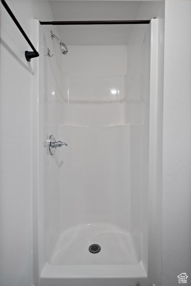 full bath featuring a shower stall