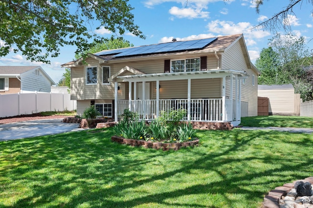 view of front of property with covered porch and solar panels