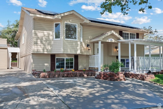 view of front of home with a porch and solar panels