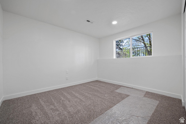empty room with carpet flooring, baseboards, and recessed lighting