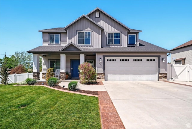 craftsman-style house with stone siding, driveway, and covered porch