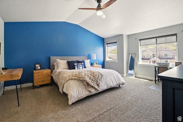 carpeted bedroom with vaulted ceiling, baseboards, and a ceiling fan