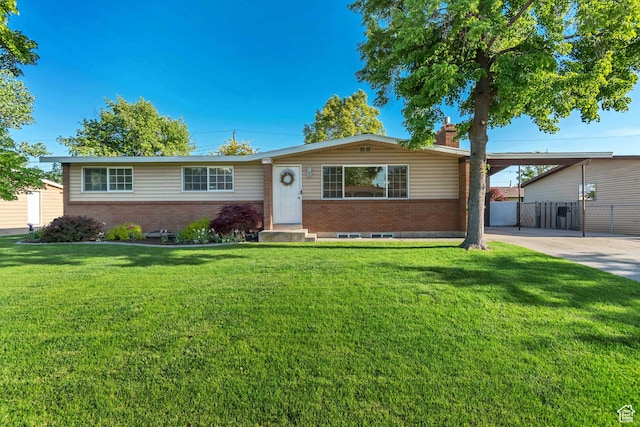 1597 W 1050 N, Provo, UT 84604 - single story home with brick siding, a chimney, an attached carport, and concrete driveway