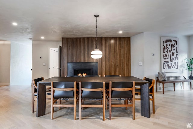 4279 S Lares Cir, Salt Lake City, UT 84124 - dining room with a lit fireplace, recessed lighting, and light wood-style floors