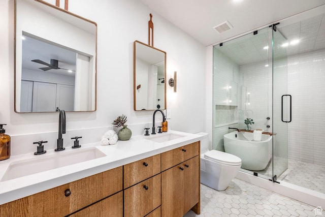 4279 S Lares Cir, Salt Lake City, UT 84124 - full bathroom featuring toilet, double vanity, a shower stall, a ceiling fan, and a freestanding bath