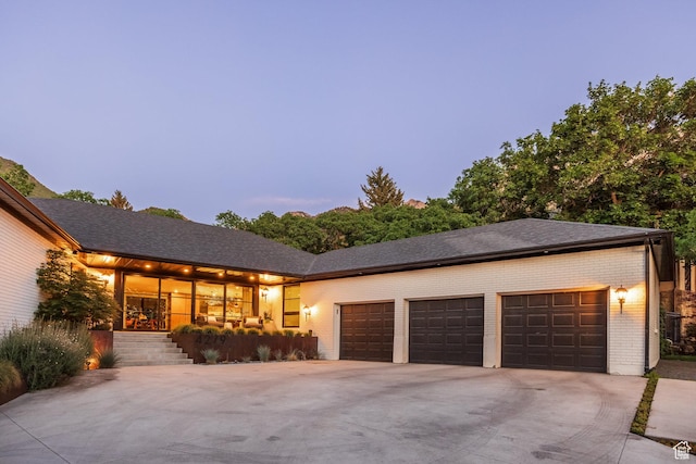 4279 S Lares Cir, Salt Lake City, UT 84124 - view of front of home with driveway, brick siding, and a garage