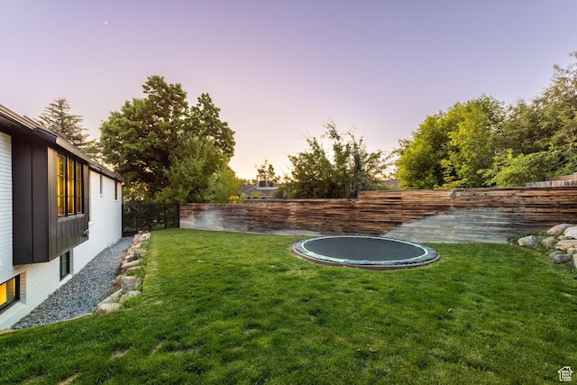 4279 S Lares Cir, Salt Lake City, UT 84124 - yard at dusk featuring a trampoline